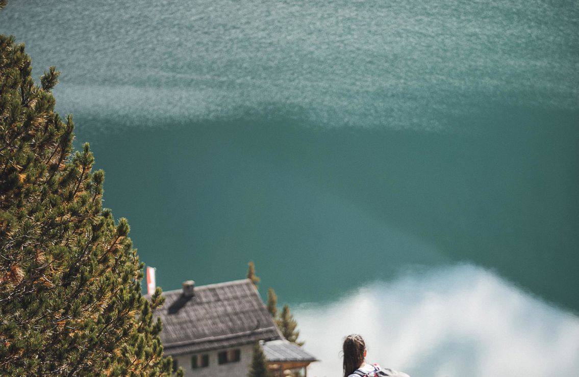 A couple is hiking near a lake